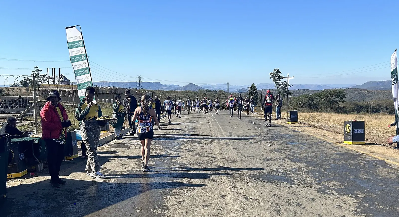 Runners on a rural road at Camperdown during the 2024 Comrades Marathon