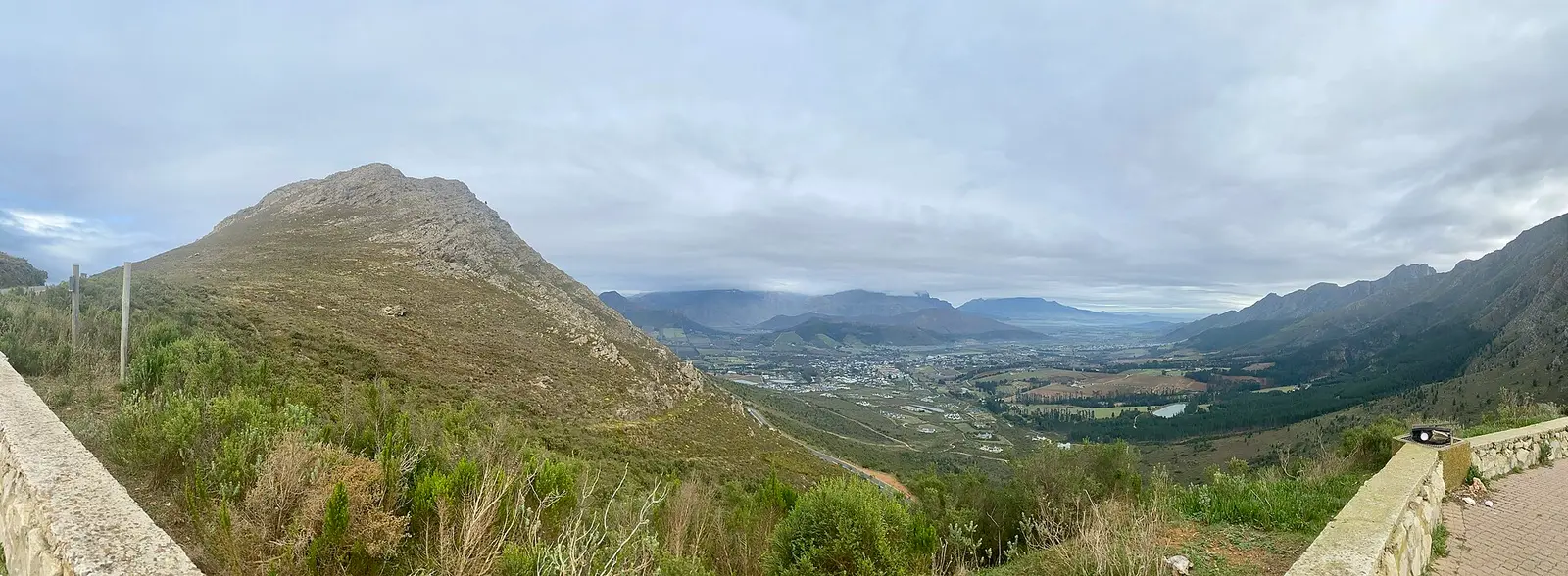 View over the Franschhoek valley from a mountain slope under cloud