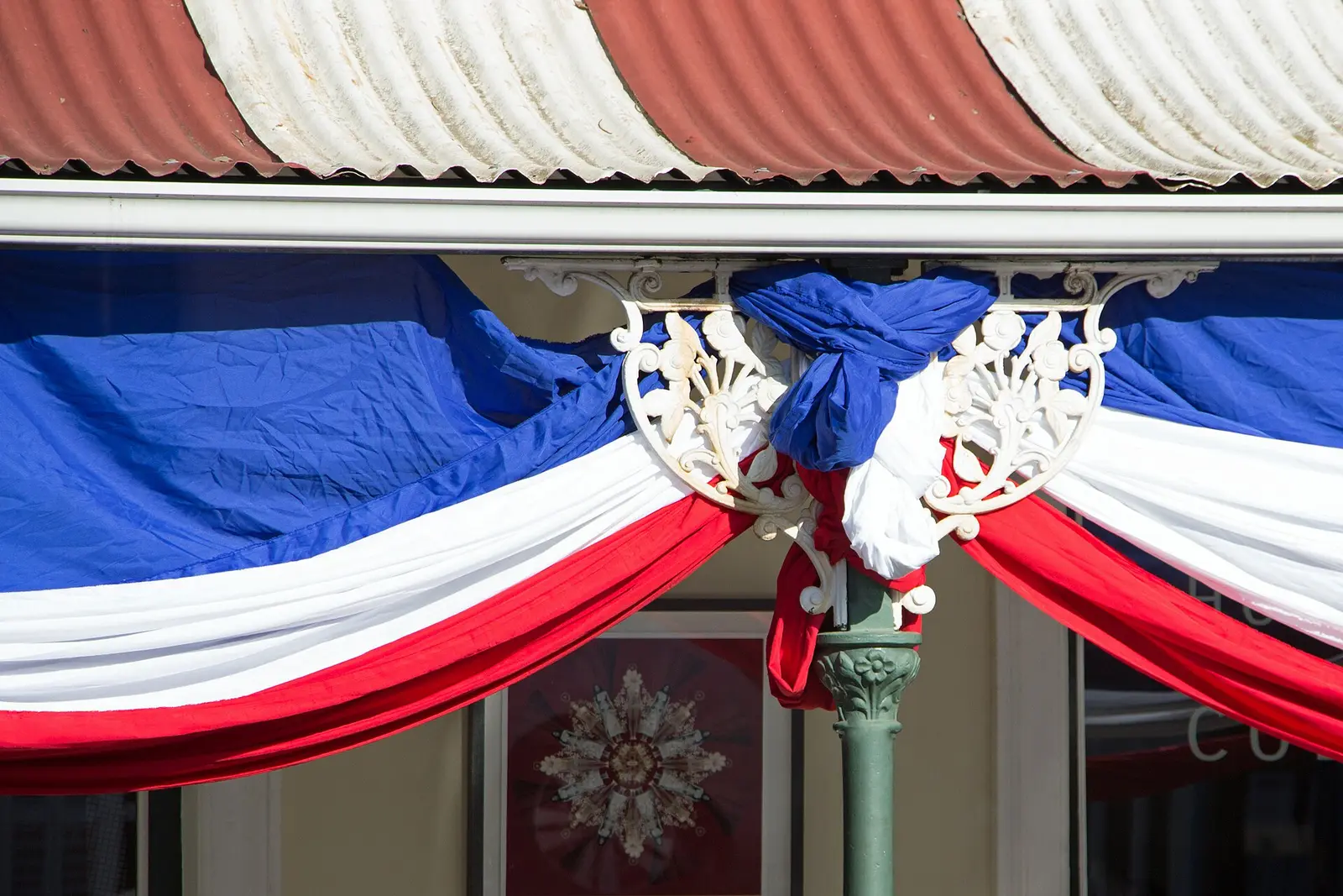 Red, white and blue bunting draped over a shopfront during the Bastille Festival in Franschhoek