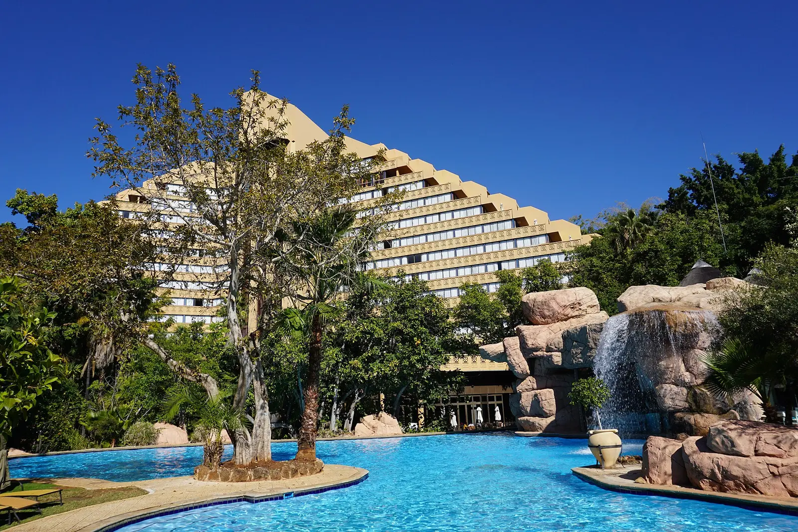 Hotel tower, pool and waterfall rocks at the Sun City resort