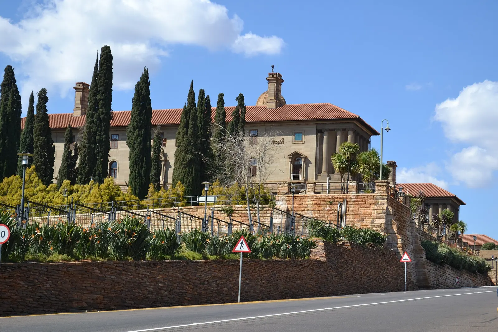 The Union Buildings in Pretoria seen from the road below with cypress trees