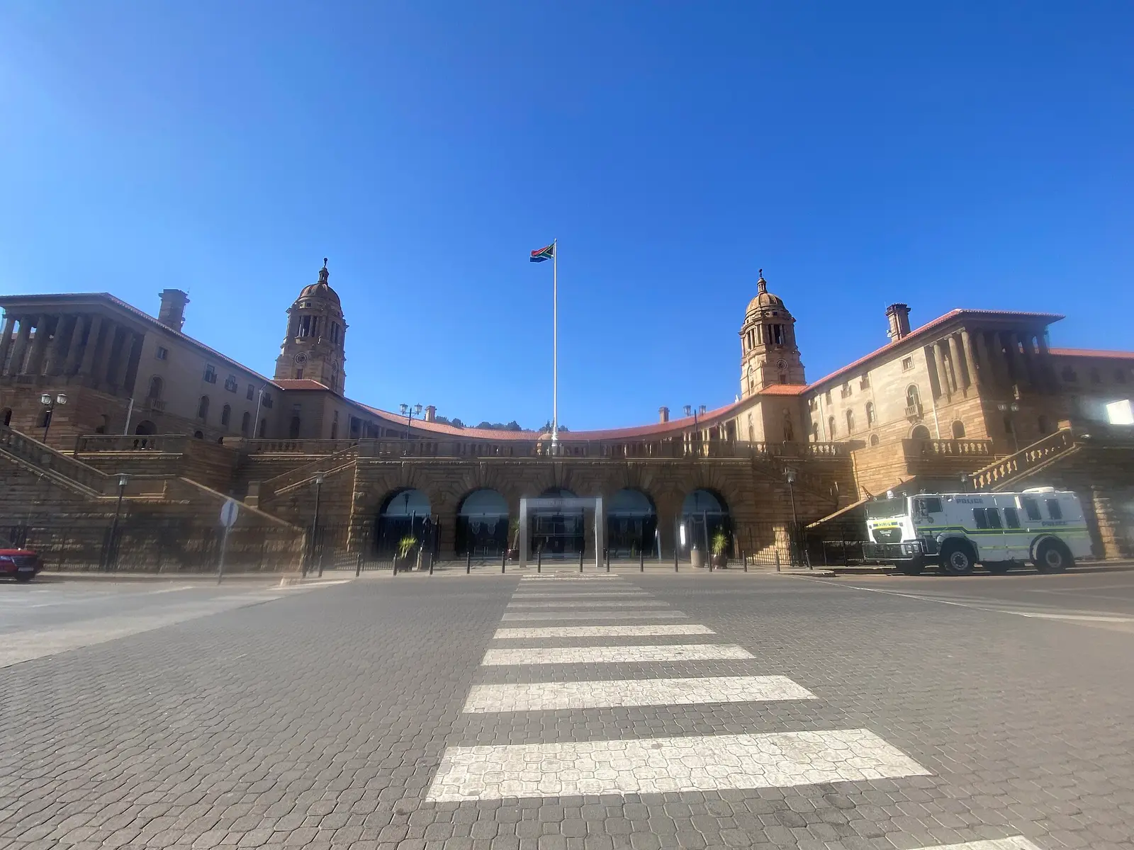 Front of the Union Buildings in Pretoria with a flag and a crosswalk